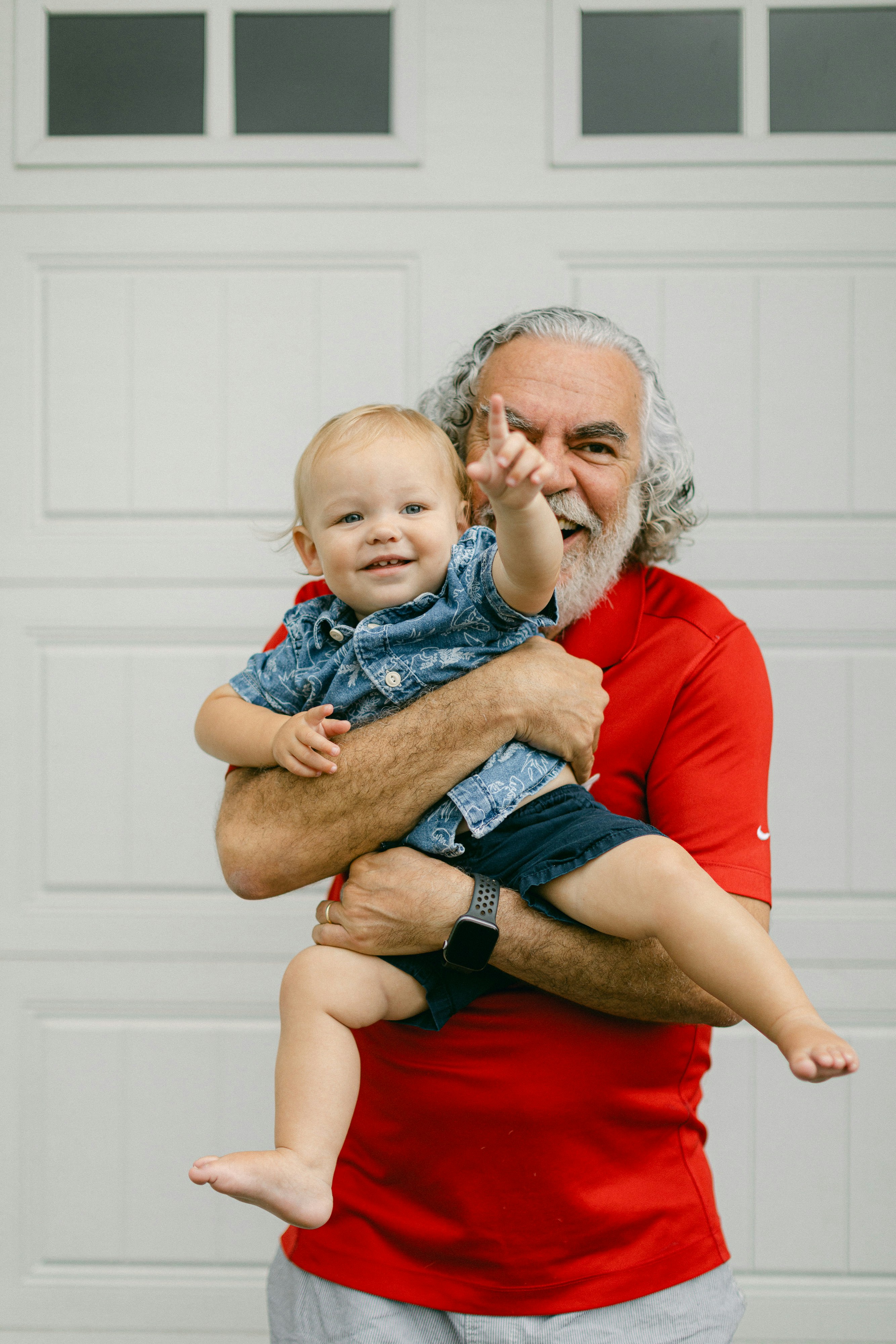 Grandfather holding smiling baby boy, symbolizing legacy and lifelong life insurance protection