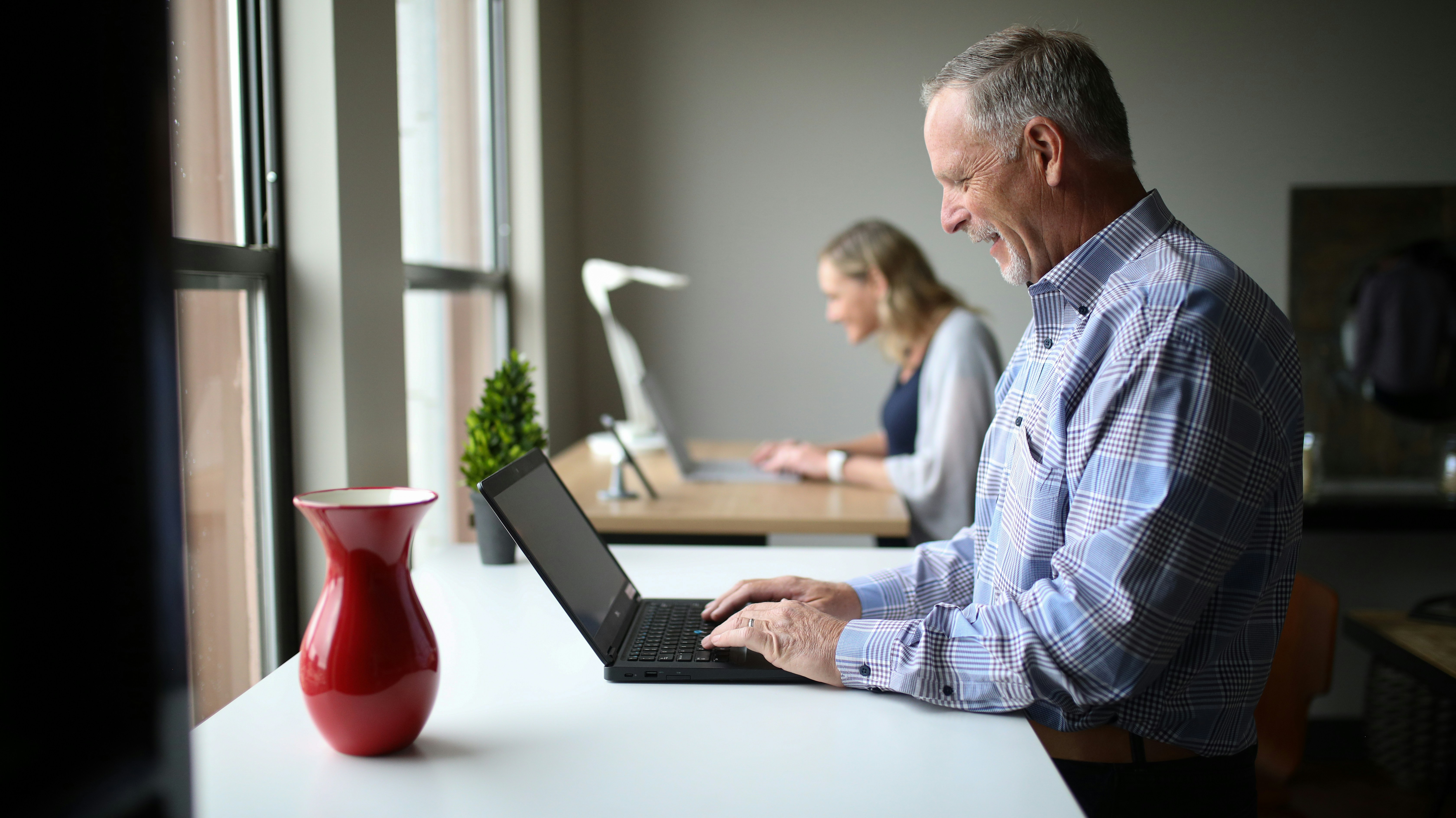 Senior man researching Medicare options on laptop, representing personalized online Medicare guidance.