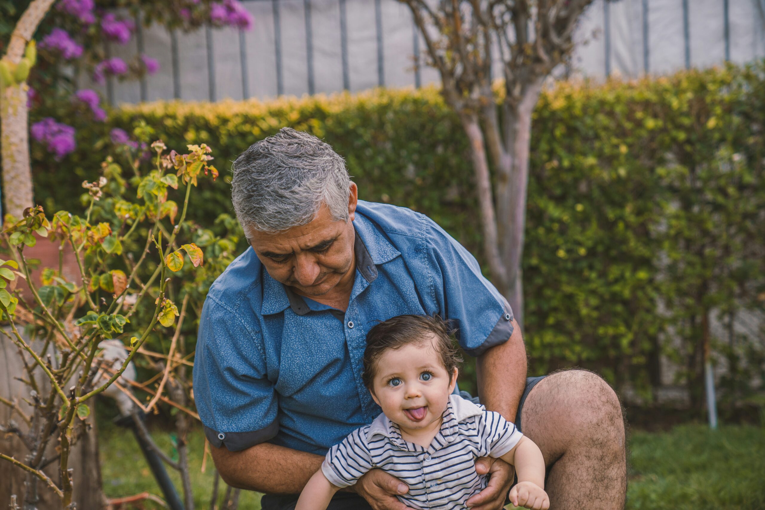Grandfather holding grandson outdoors, symbolizing peace of mind from the right Medicare coverage.